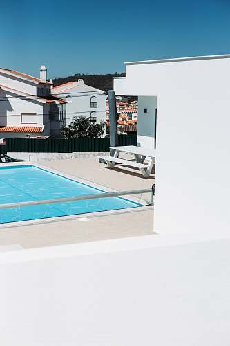 sport swimming pool beside picnic table during daytime team
