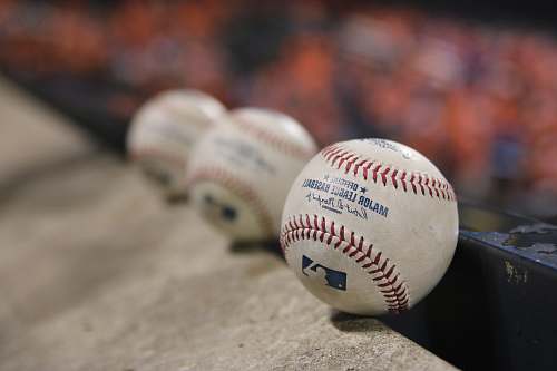 sport three white baseballs on gray textile baseball