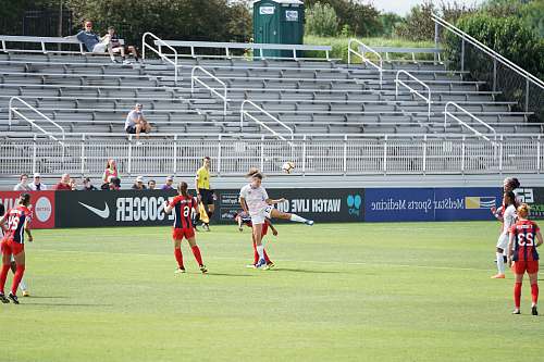 sport photo of woman kicking soccer ball sports