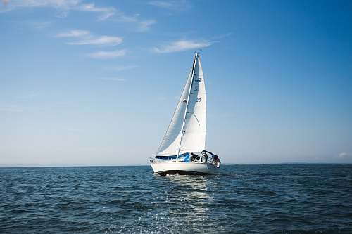 vessel blue and white sailboat on ocean during daytime sailboat