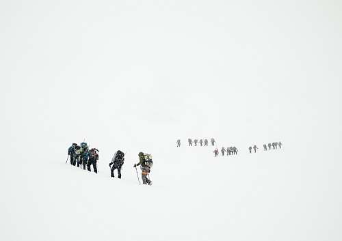 snow group of mountaineers hiking on snowy mountain people
