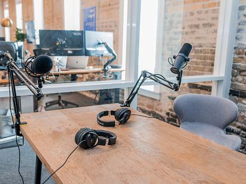 plywood two black headphones on brown wooden table hardwood