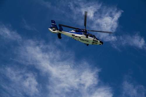 helicopter low-angle photography of white and blue helicopter transportation