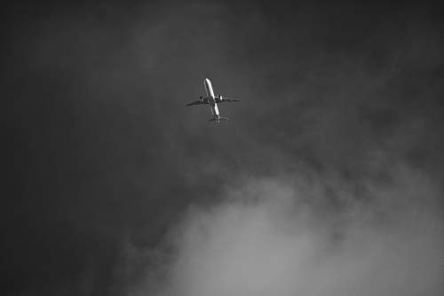 grey greyscale photography of flying plane black-and-white