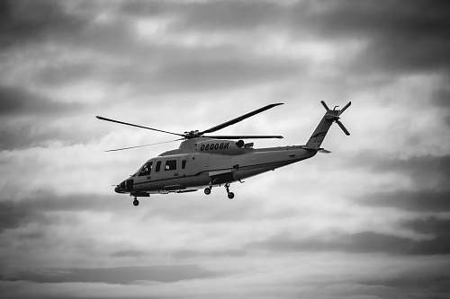 black-and-white gray helicopter on flight grayscale photo helicopter