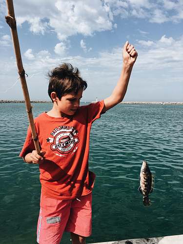 fish boy holds fish perch