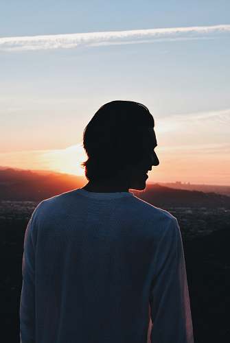 clothing smiling man wearing white crew-neck long sleeved shirt looking left side sleeve