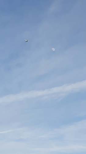 flying white and red plane blue