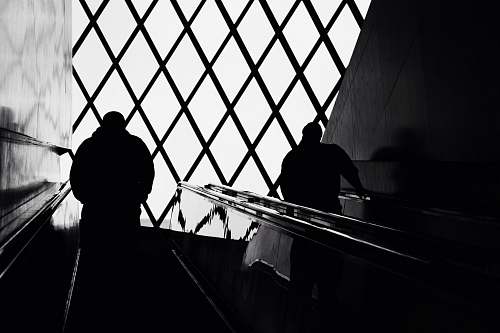 banister man standing on escalator handrail