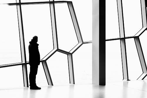silhouette silhouette photo of person standing near window person