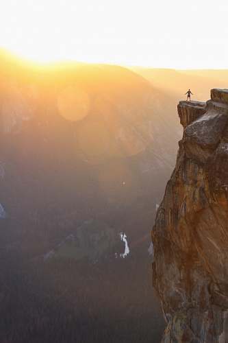 outdoors silhouette of person standing on cliff during sunset person