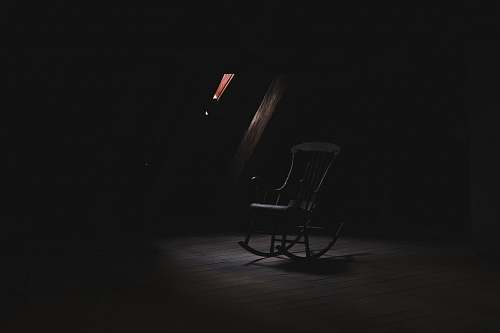 chair brown wooden rocking chair inside dark room furniture
