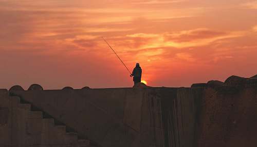 sun silhouette of person standing during golden hour man