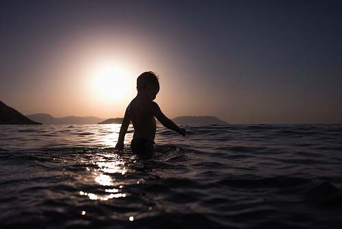 people boy standing on body of water beach
