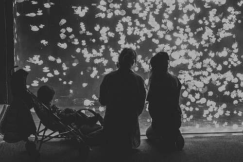black-and-white grayscale photography of couple with child in stroller people