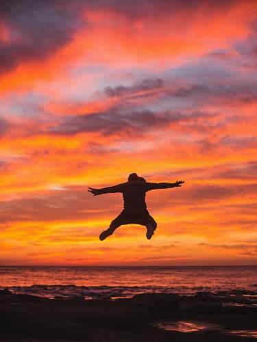 nature man jumping in seashore outdoors