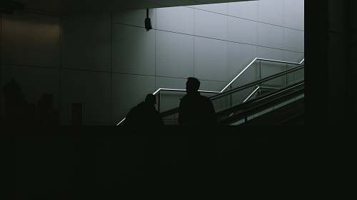 banister man standing on gray stair handrail