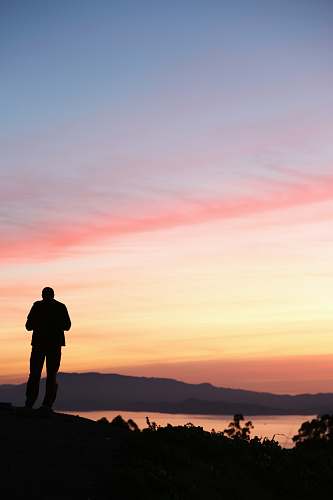 person man stands on top of the mountains standing