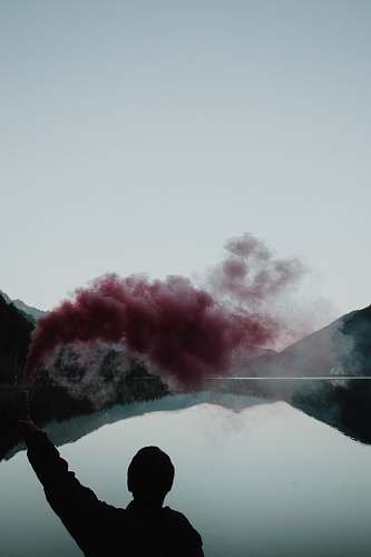 people person spray red smoke person