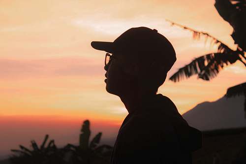 person person wearing a eyeglasses and hat during golden hour apparel