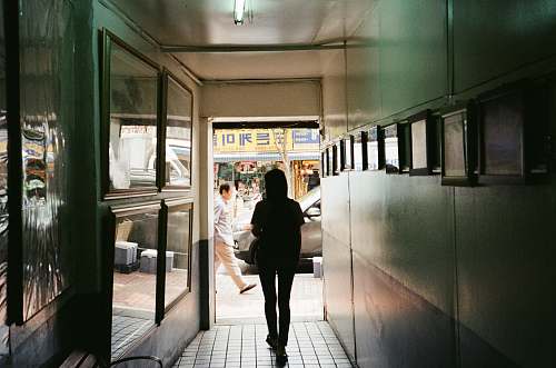 person silhouette of a woman walking at the corridor people