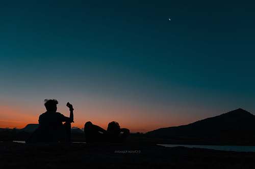 person silhouette of man with phone at dusk silhouette