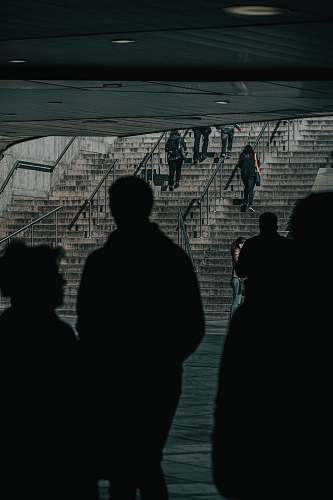banister silhouette of people inside subway handrail