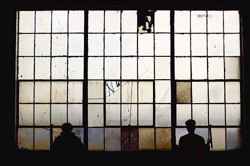 person silhouette of people standing near window people