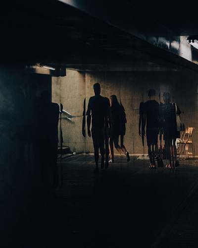 person silhouette of people walking near building pedestrian