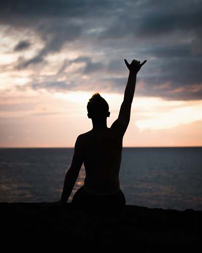 person silhouette of person raising hands near shore people