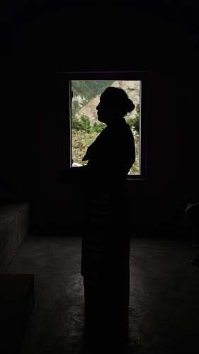 person silhouette of woman standing inside room people