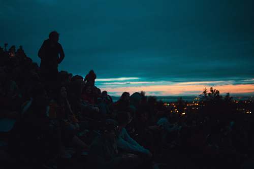 person silhouette photo of people on top of the mountain people