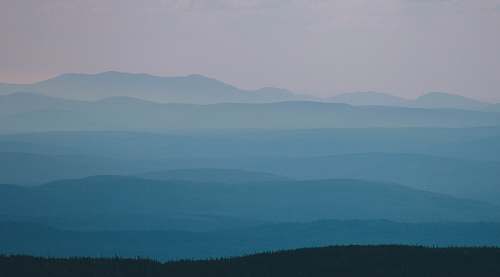 layers mountains covered in fog ridge