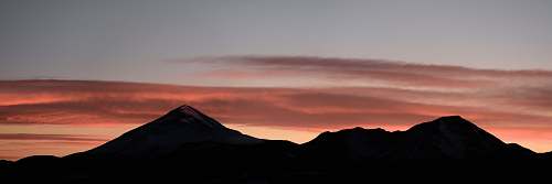 sky silhouette photo of mountains in sunset sunrise