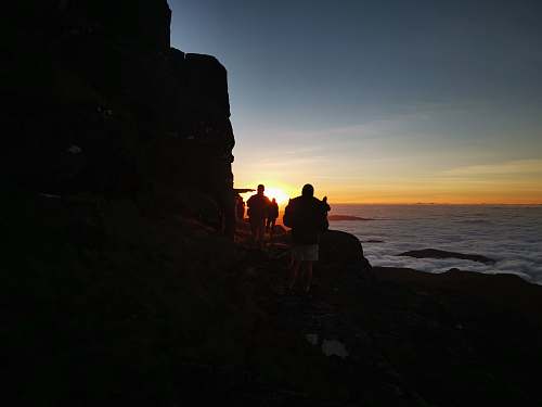 human people walking on rock cliff person