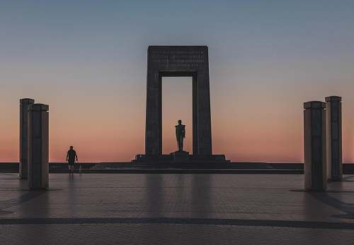 person person walking by monument during golden houre human