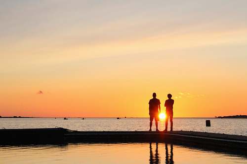 human silhouette of coupe on shore person