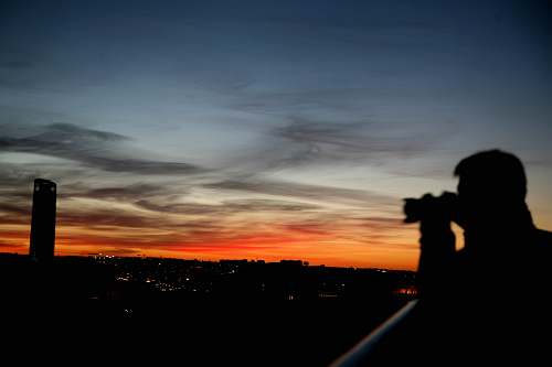 outdoors silhouette of man taking photo dawn
