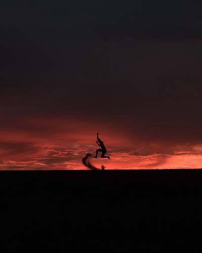 outdoors silhouette of person jumping sunset