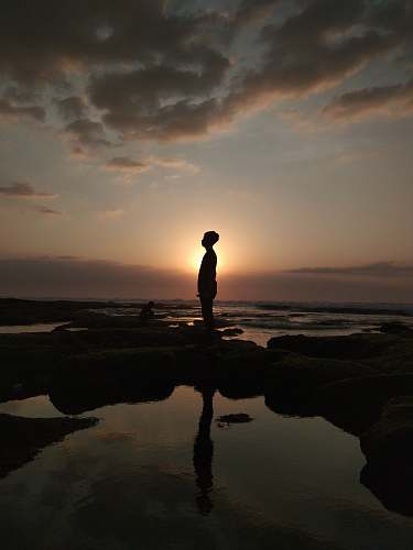 outdoors silhouette of person standing while facing left side silhouette