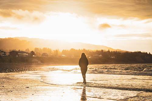 outdoors silhouette of person walking on seashore human