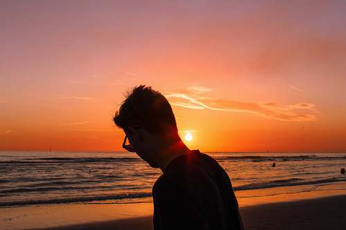 human silhouette photography of man on shore person