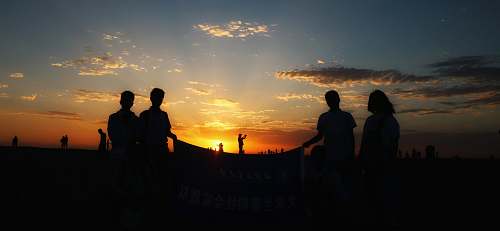 human silhouette photography of people under clear blue sky person