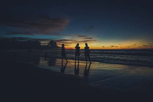 outdoors three person on the seashore photography ocean