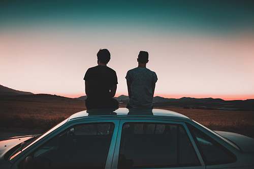 person two men sitting on vehicle car