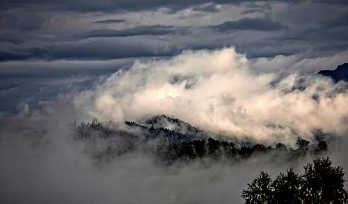 cloud white clouds on top of a mountain cloudy