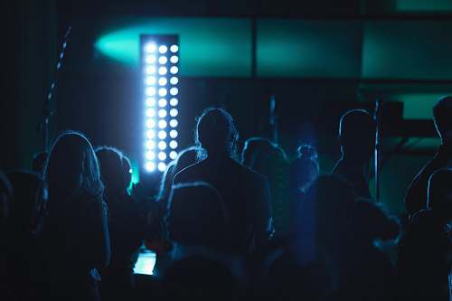 blue people standing near tower light inside room crowd