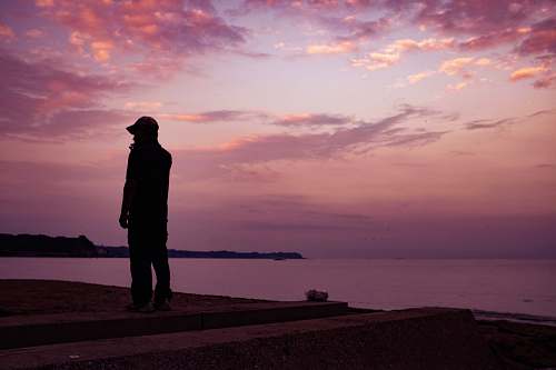 person silhouette of man standing on seashore human