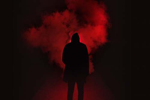 person silhouette of person on a dark place with smoke silhouette