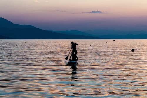 person silhouette of person riding on boat greece